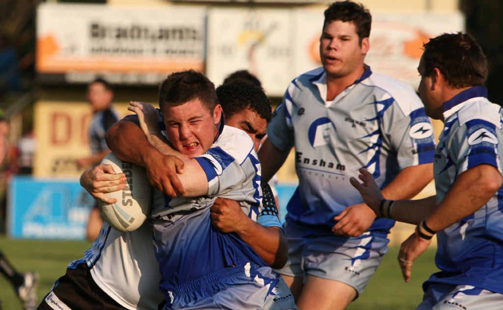 An Ensham Mine player on the receiving end of some stiff defence from Biloela Callide Crusaders. An Ensham Mine player on the receiving end of some stiff defence from Biloela Callide Crusaders.